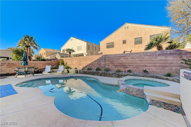 view of pool with pool water feature, an in ground hot tub, and a patio area