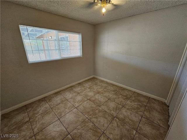 empty room featuring a textured ceiling, ceiling fan, and tile patterned floors