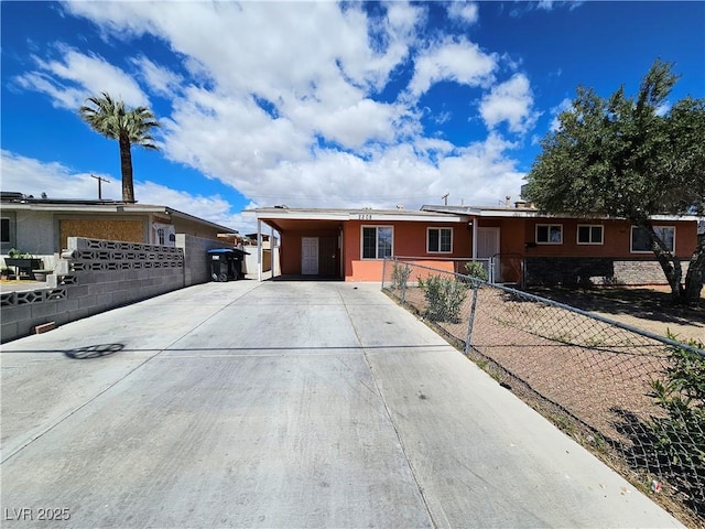 ranch-style house featuring a carport