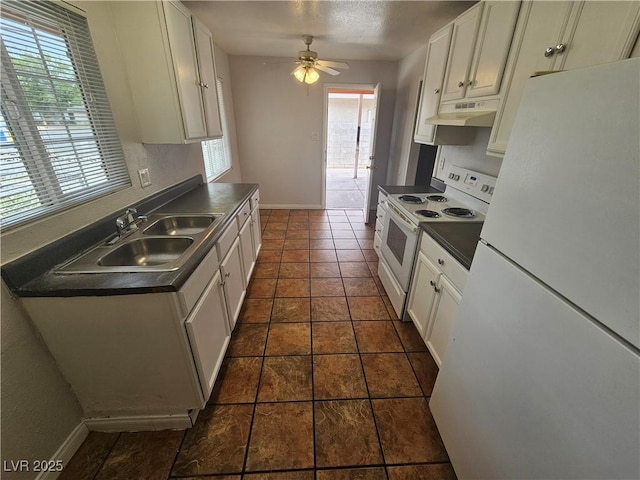 kitchen with white appliances, dark tile patterned flooring, white cabinetry, ceiling fan, and sink