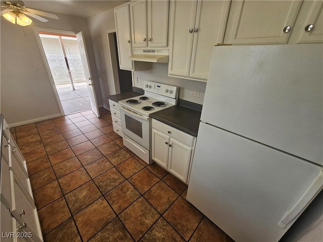 kitchen featuring dark tile patterned floors, white appliances, and ceiling fan