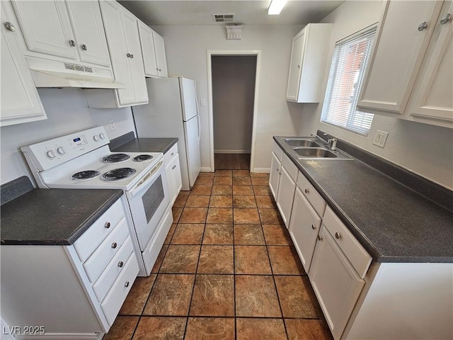 kitchen with white appliances, white cabinetry, dark tile patterned floors, and sink