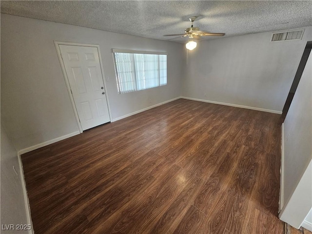 unfurnished room featuring a textured ceiling, ceiling fan, and dark hardwood / wood-style flooring