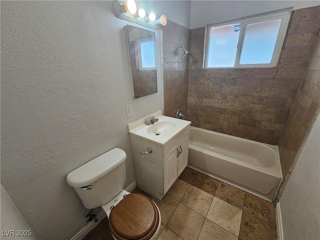 full bathroom with tiled shower / bath combo, vanity, and toilet