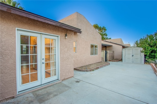 exterior space with a patio area, french doors, and a storage shed