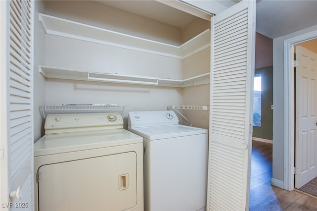 washroom featuring wood-type flooring and washing machine and clothes dryer