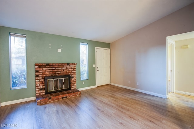 unfurnished living room with light wood-type flooring and a fireplace