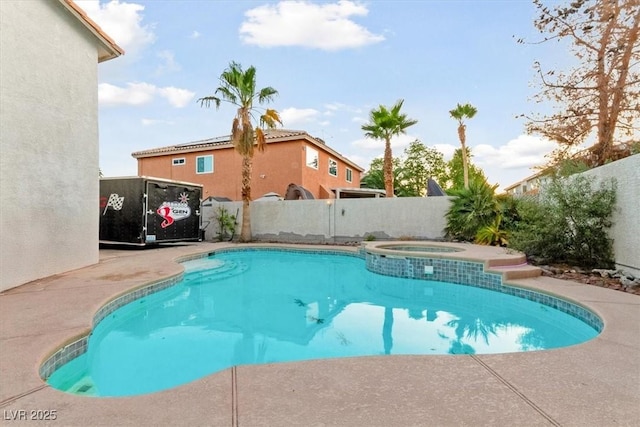 view of swimming pool with an in ground hot tub