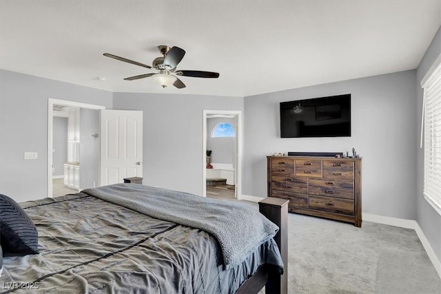 carpeted bedroom with ceiling fan, multiple windows, and ensuite bath