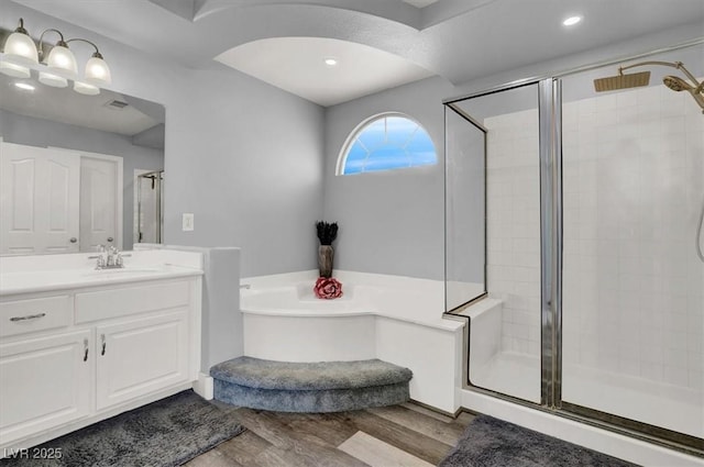 bathroom with shower with separate bathtub, vanity, and hardwood / wood-style flooring