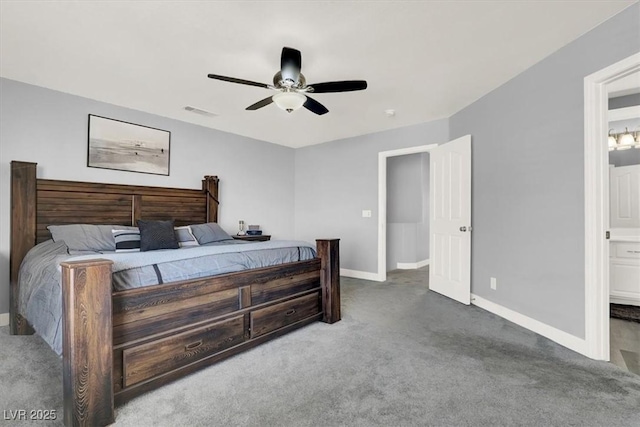 carpeted bedroom with ensuite bath and ceiling fan