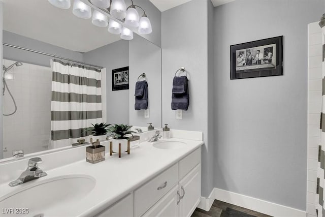 bathroom featuring curtained shower and vanity