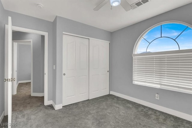 unfurnished bedroom featuring a closet, ceiling fan, and carpet