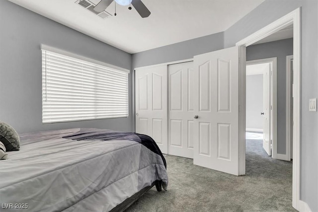 bedroom with a closet, ceiling fan, and light colored carpet