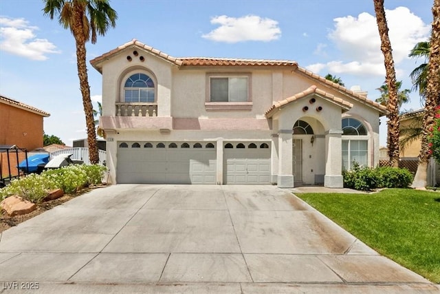 mediterranean / spanish home with a front lawn and a garage