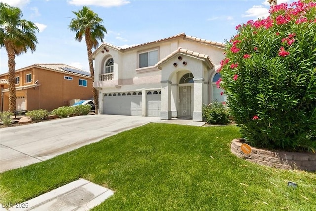 mediterranean / spanish-style home with a front yard and a garage