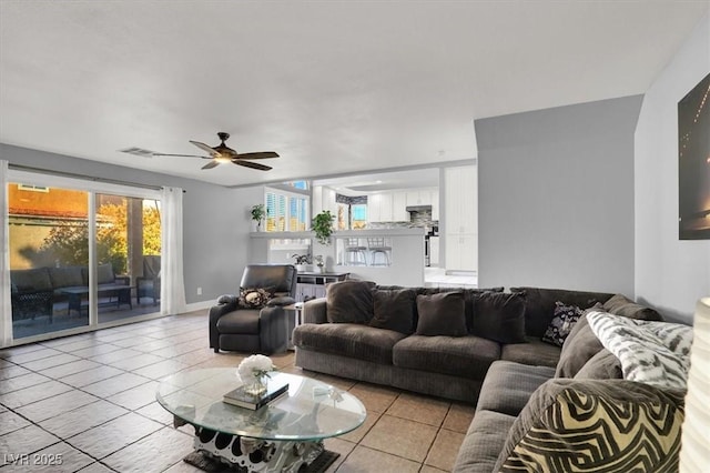 tiled living room with ceiling fan