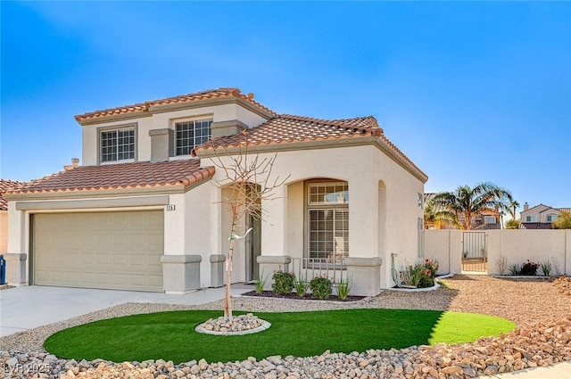 mediterranean / spanish house with a garage