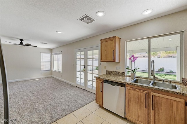 kitchen featuring stainless steel dishwasher, french doors, light colored carpet, ceiling fan, and sink