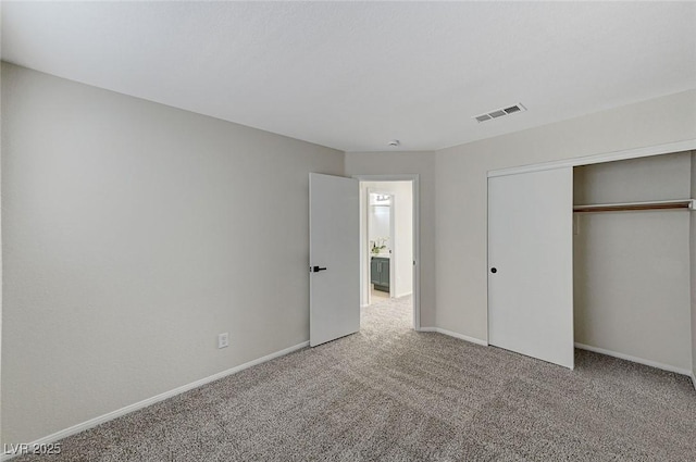 unfurnished bedroom with a closet and carpet flooring