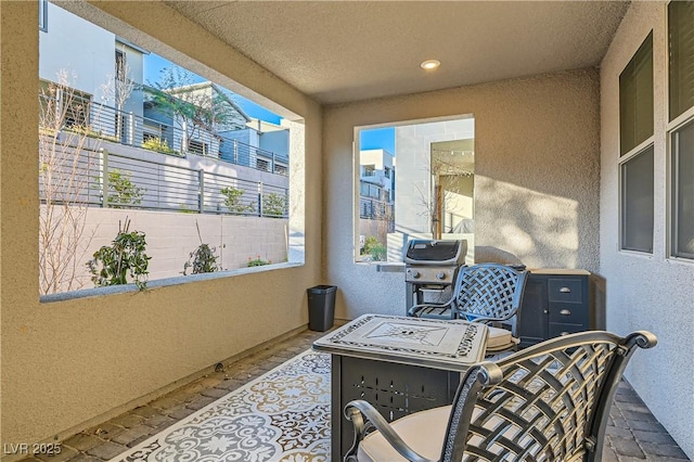 view of patio with area for grilling and a balcony