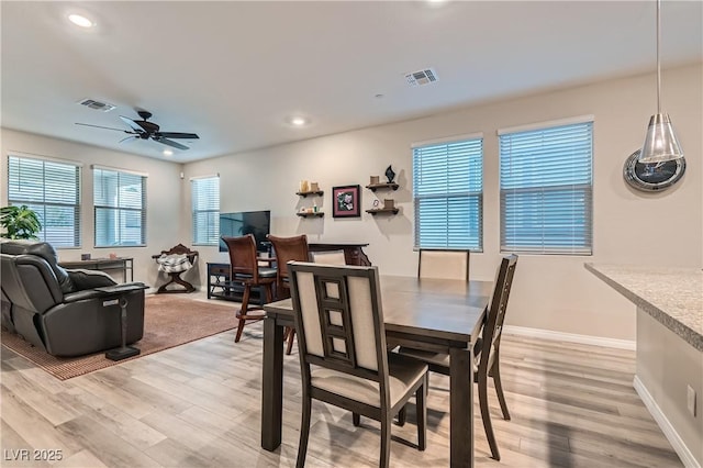 dining room featuring ceiling fan, a healthy amount of sunlight, and light hardwood / wood-style floors