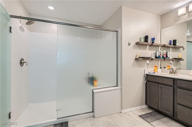 bathroom with tile patterned floors, a shower with shower door, and vanity