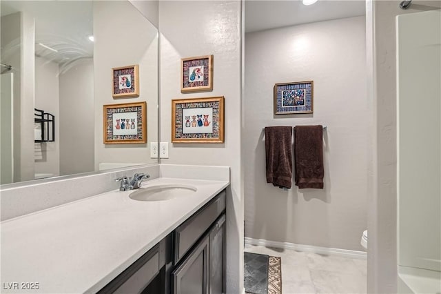 bathroom featuring vanity and toilet