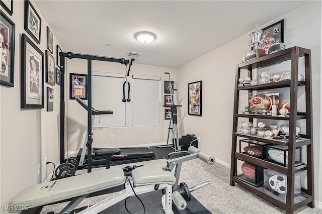 workout room with a textured ceiling and carpet