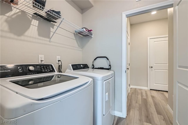 washroom featuring separate washer and dryer and light wood-type flooring