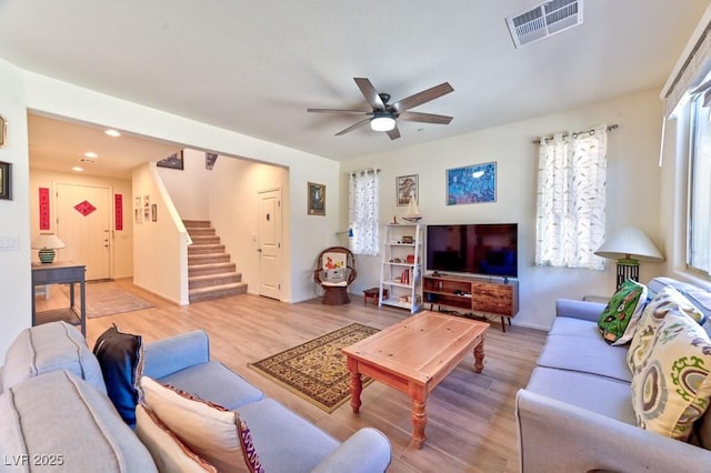 living room with ceiling fan and light hardwood / wood-style flooring