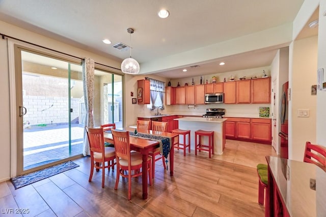 dining room featuring light wood-type flooring and sink