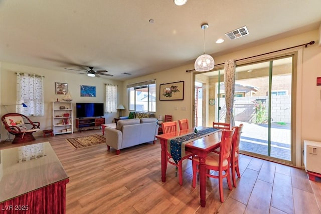 dining space featuring hardwood / wood-style floors and ceiling fan