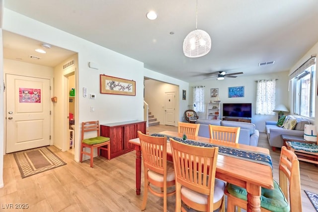 dining space featuring ceiling fan and light wood-type flooring