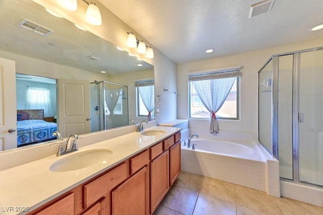 bathroom featuring vanity, shower with separate bathtub, and tile patterned flooring