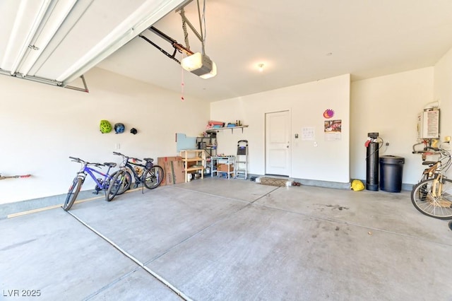 garage with a garage door opener and water heater