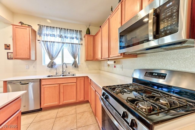 kitchen featuring sink, light tile patterned floors, and appliances with stainless steel finishes