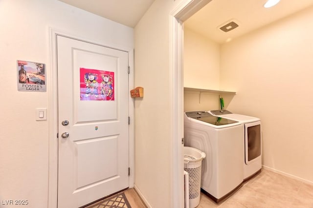 laundry area with washing machine and clothes dryer