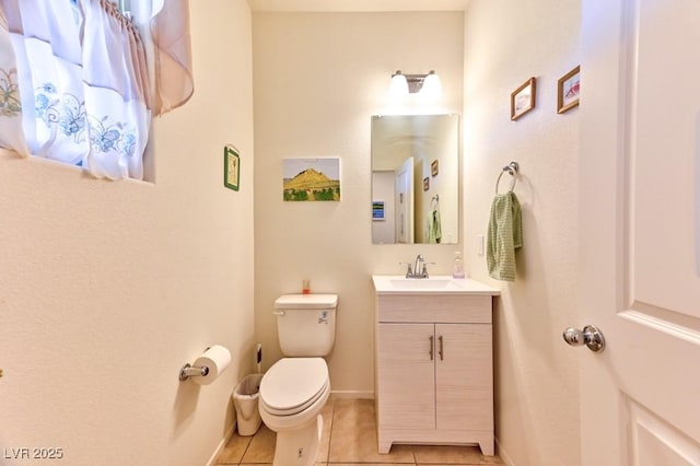 bathroom featuring toilet, tile patterned floors, and vanity