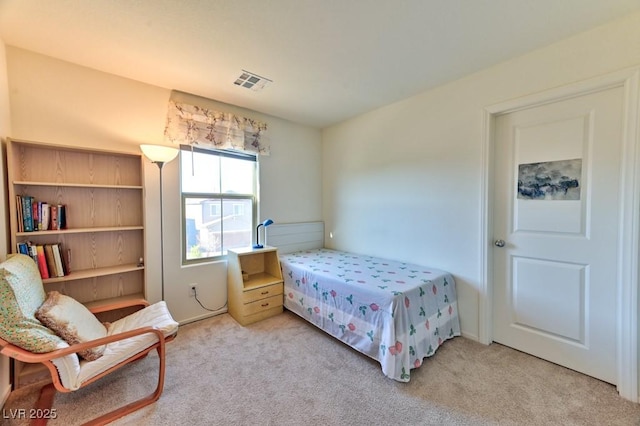 bedroom featuring light colored carpet