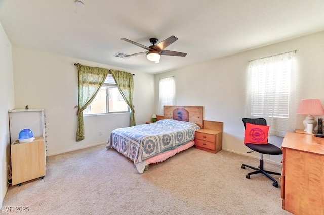 bedroom with ceiling fan and light carpet