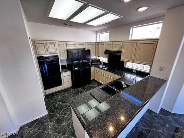 kitchen with light brown cabinets, black appliances, and kitchen peninsula