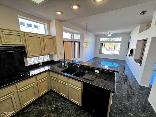 kitchen featuring kitchen peninsula, range hood, black appliances, ceiling fan with notable chandelier, and sink