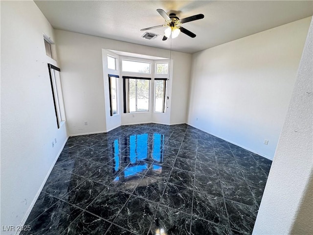 spare room featuring ceiling fan