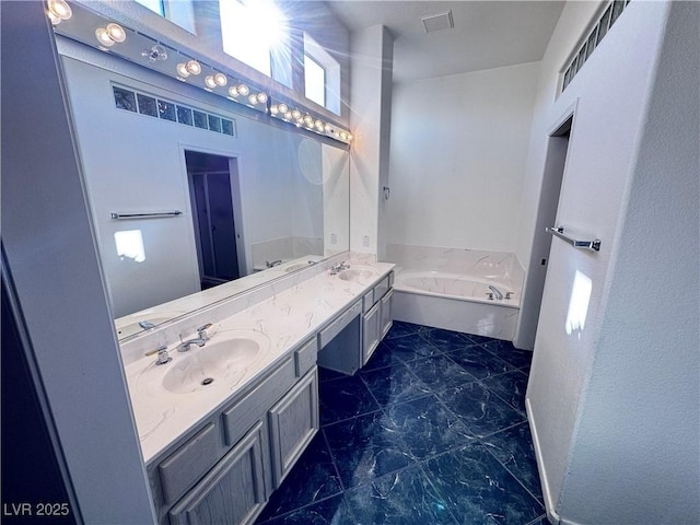 bathroom featuring vanity and a bath