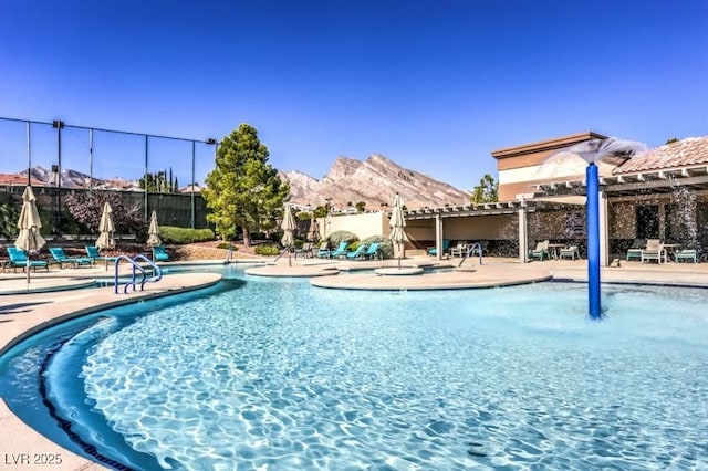 view of swimming pool featuring a patio, a pergola, and a mountain view