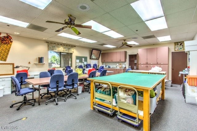 game room featuring carpet floors, a drop ceiling, and ceiling fan