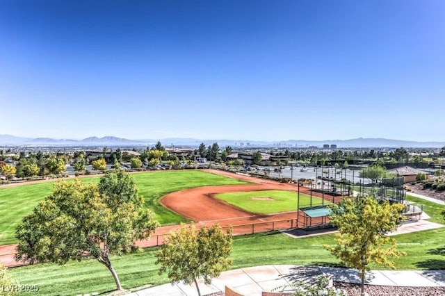 view of community with a lawn and a mountain view