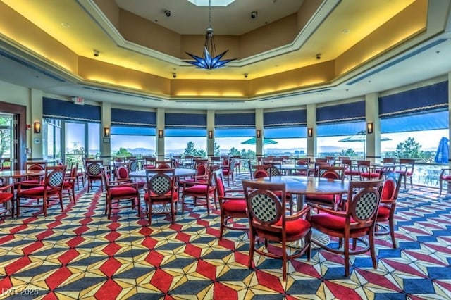 dining room with a high ceiling and a tray ceiling