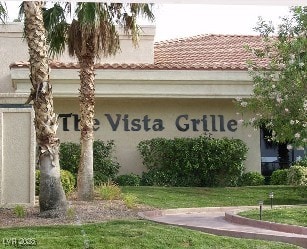 community / neighborhood sign with a lawn